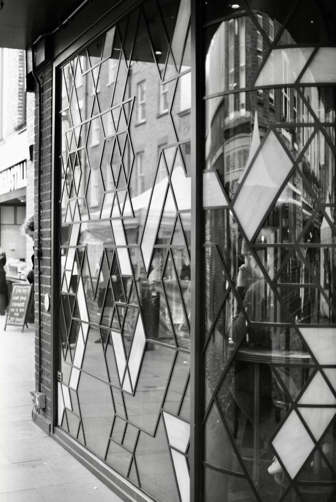 A cut glass leaded window with clear reflections